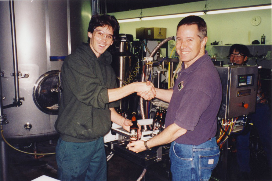 Lee Chase and Steve Wagner Lee Chase and Steve Wagner showcasing our first ever 12 oz. bottle with Stone Brewer, Toshi Ishii looking on. Note that the "Maheen" bottling machine in the background is roughly the size of the three of them.